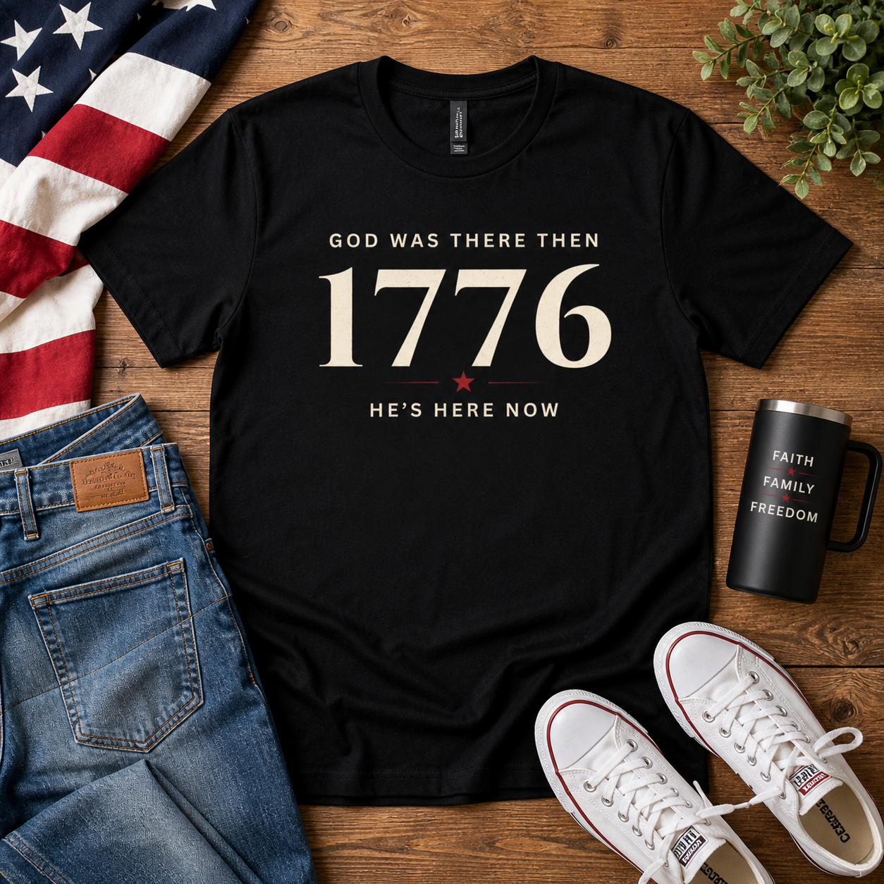 Flat lay of Bella+Canvas unisex faith and freedom t-shirt featuring the "God Was There Then — He's Here Now" vintage patriotic design. Soft everyday graphic tee from the American Soul Collection.