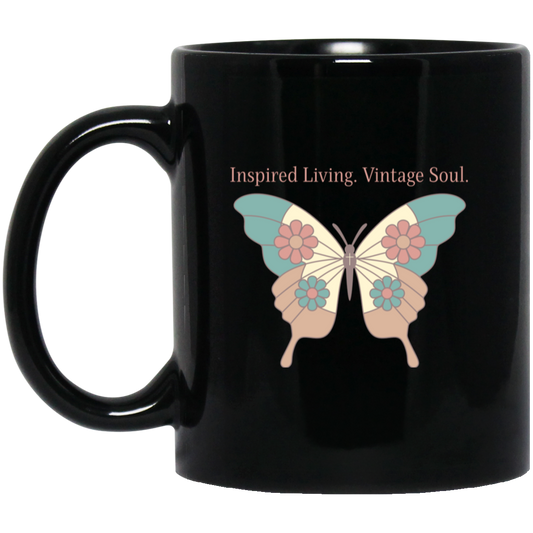 Vintage butterfly coffee mug featuring Inspired Living. Vintage Soul. text with teal, coral, and cream butterfly artwork on a black ceramic mug.