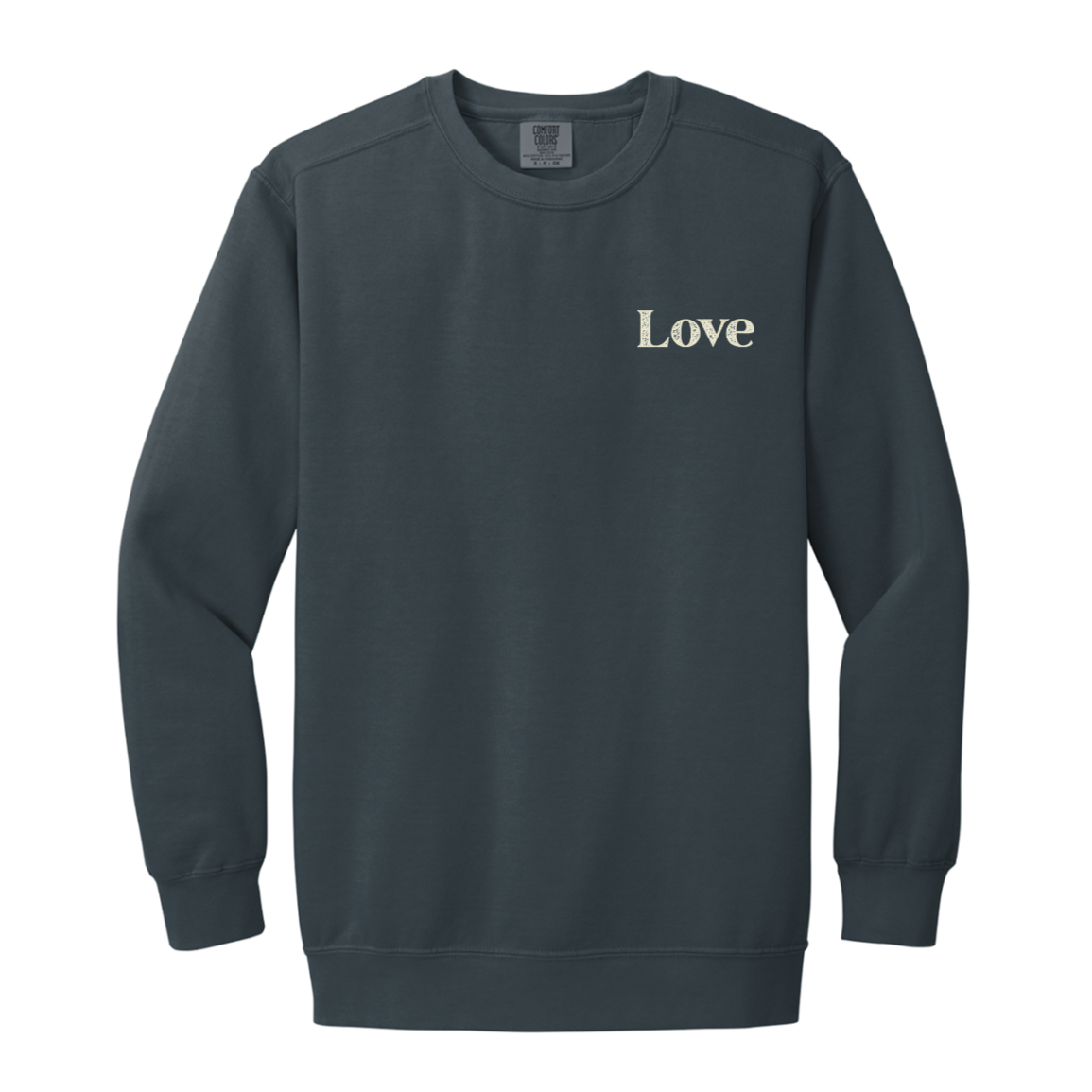 Denim Comfort Colors crewneck sweatshirt with a small cream Love design printed on the front left chest.