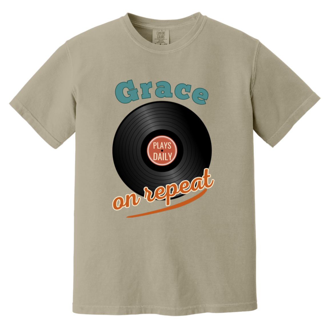 Vintage-inspired Sandstone Comfort Colors t-shirt featuring a retro vinyl record graphic with the phrase “Grace Plays Daily on Repeat” in muted teal and dusty coral tones.