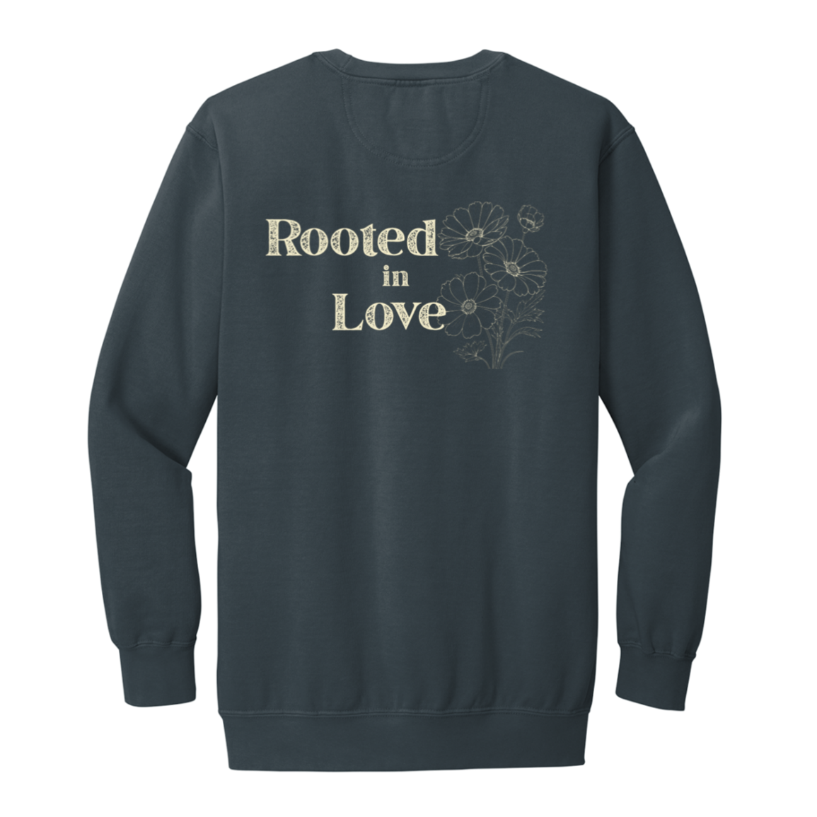 Back of a Denim Comfort Colors crewneck sweatshirt featuring a large Rooted in Love design with vintage cream lettering and outlined flowers.