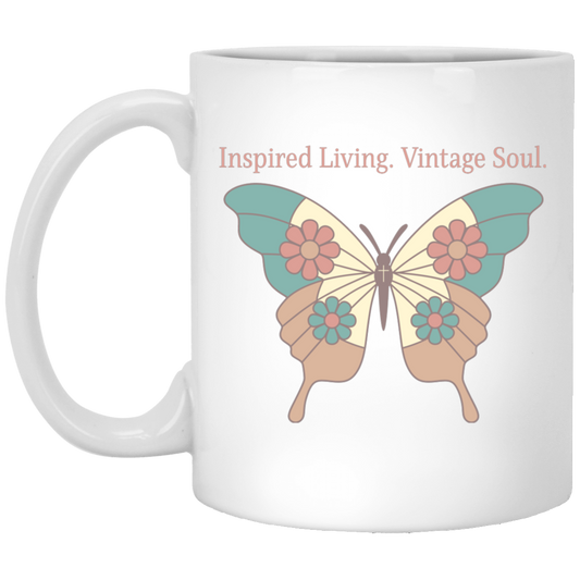 Vintage butterfly coffee mug featuring Inspired Living. Vintage Soul. text with teal, coral, and cream butterfly artwork on a white ceramic mug.