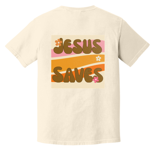 Jesus Saves retro Comfort Colors t-shirt featuring groovy vintage typography, warm 70s-inspired waves, and floral accents on an ivory garment-dyed tee.