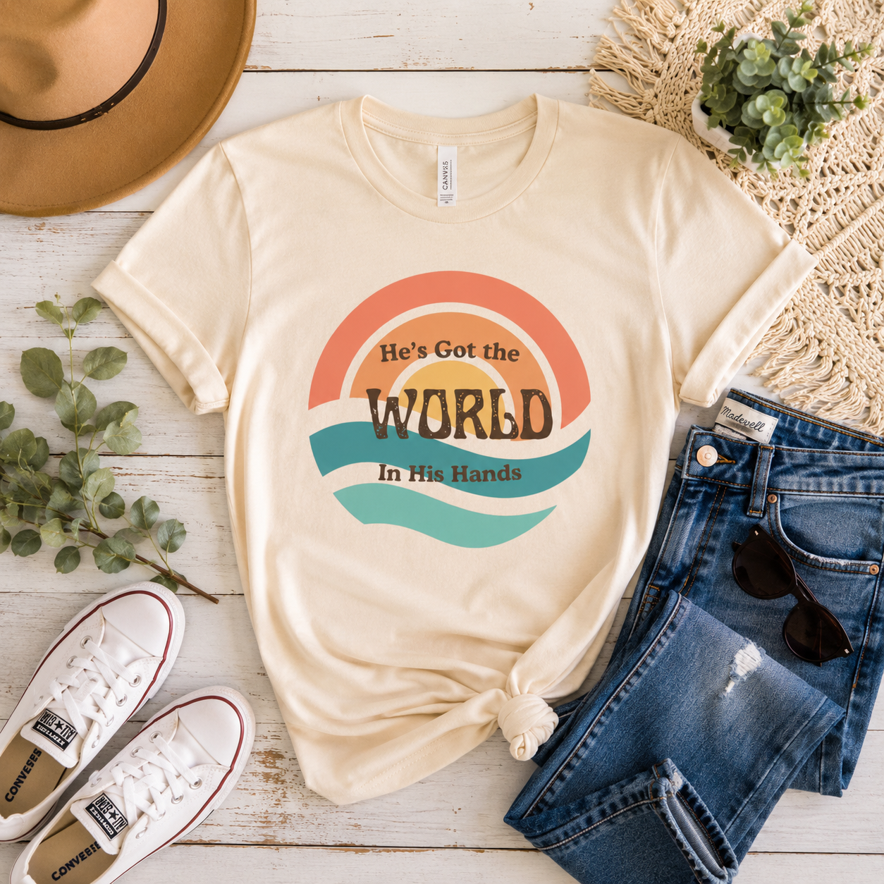 Woman wearing a vintage-inspired Bella + Canvas graphic tee with He's Got the Whole World in His Hands design and warm retro colors