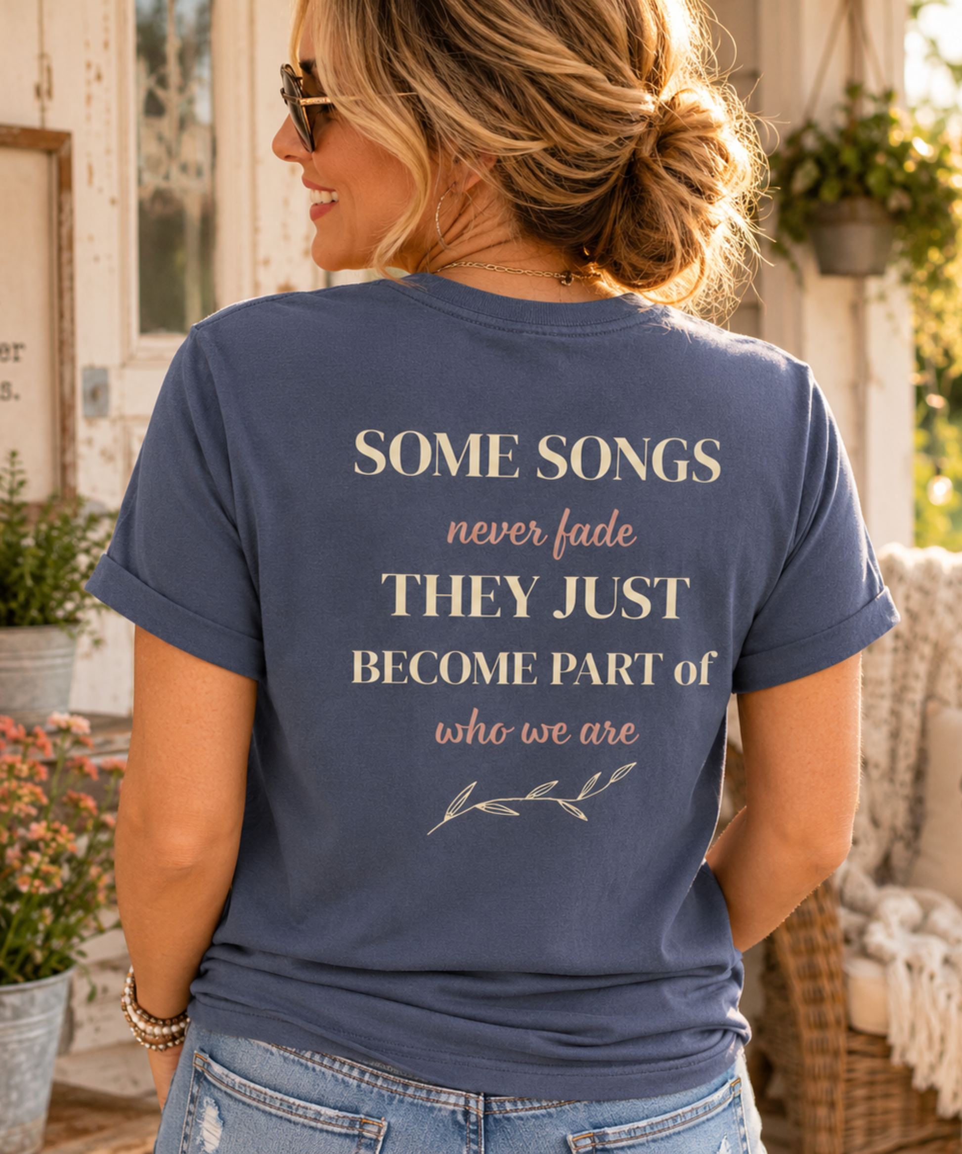 Woman wearing faded blue Comfort Colors music-inspired t-shirt with back print quote "Some Songs Never Fade, They Just Become Part of Who We Are."